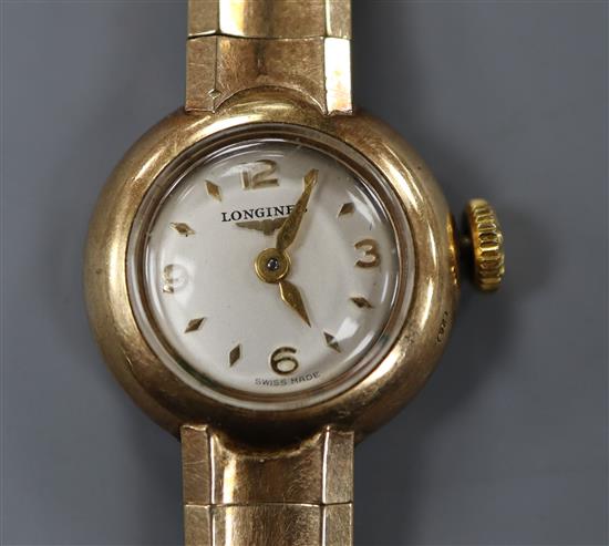 A ladys Longines 9ct gold wrist watch on flexible bracelet.